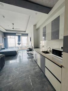 a kitchen with a sink and a bed in a room at Moonrisehomestays in Ghaziabad