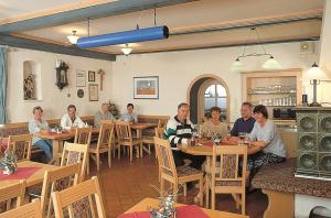 a group of people sitting at tables in a restaurant at Hotel-Gasthof Zur Linde in Neukirchen beim Heiligen Blut +19 photos
