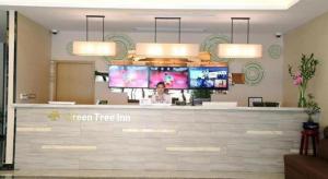 a reception counter in a hospital with several screens at GreenTree Inn Shanghai Fengxian District Xiaotang Metro Station in Xidu