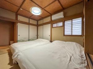a bedroom with a large white bed in it at 2nd Home Kaminagayoshi in Ichihara