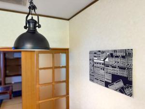 a black light hanging from a wall with a picture at 2nd Home Kaminagayoshi in Ichihara