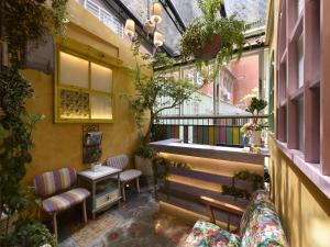 a balcony with chairs and a table and a window at DG Hotel in Taipei