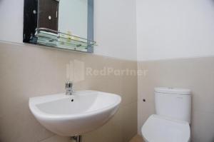 a bathroom with a white sink and a toilet at Green Residence 25 Syariah Karawaci RedPartner in Binong +15 photos