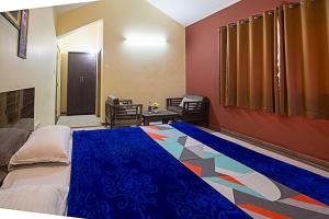 a bedroom with a blue bed and a colorful floor at S&K villa 3 BHK PRIVATE POOL in Lonavala
