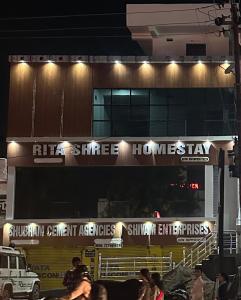 a building with a sign on the side of it at Rita Shree Homestay At Ayodhya Highway in Sultānpur