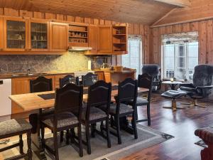 a kitchen with a wooden table and chairs at 8 person holiday home in BJELLAND-By Traum in Bjelland