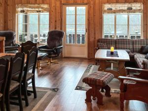 a living room with couches and a table and chairs at 8 person holiday home in BJELLAND-By Traum in Bjelland