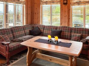 a living room with a couch and a wooden table at 8 person holiday home in BJELLAND-By Traum in Bjelland