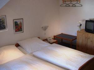 Un pat sau paturi într-o cameră la Hotel Urbanus
