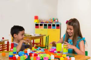 a boy and a girl playing with blocks at a table at Iberostar Selection Diar El Andalous in Port El Kantaoui