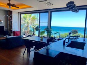 a living room with a kitchen with a view of the ocean at The House of Ocean in Nachikatsuura +18 photos