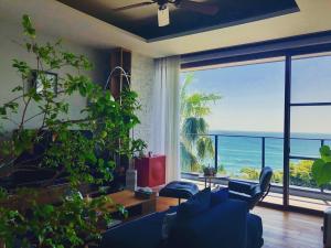 a living room with a view of the ocean at The House of Ocean in Nachikatsuura