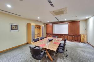 a conference room with a large wooden table and chairs at Ramada by Wyndham Istanbul Old City in Istanbul