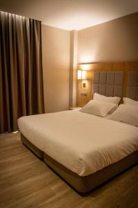 Postel nebo postele na pokoji v ubytování C un petit hotel avec 16 chambre et 3 suite et un restaurant et une cafétéria