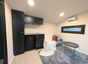 a living room with a couch and a table at Spa Cabin by Hossaville in Hossa +34 photos