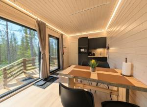 a kitchen and dining room with a table and chairs at Spa Cabin by Hossaville in Hossa