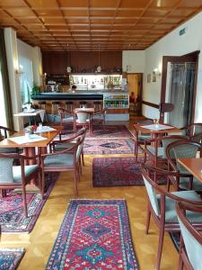 a restaurant with wooden tables and chairs and a counter at Drei Quellen Hotel Kipper in Bad Gams