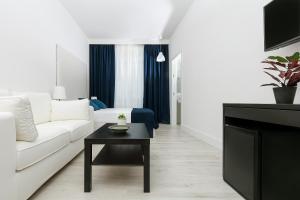 a living room with a white couch and a table at Fuorlovado 40 in Capri