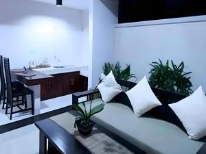 a living room with a couch and a table at Evita Villas in Sukawati