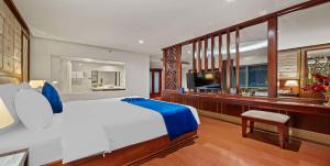 a bedroom with a large bed and a television at Sandals Stay Hotel in Da Nang