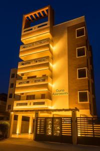 a building with a gtinauts sign on it at night at Elegant Residency in Coimbatore