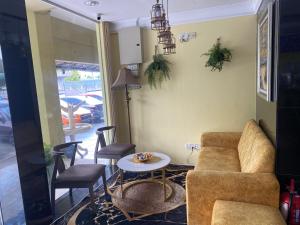a living room with a couch and chairs and a table at Five Ferns Hotel in Bandar Baru Bangi