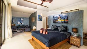 a bedroom with a bed and a couch at Khwan Beach Resort - Luxury Glamping and Pool Villas Samui - Adults Only - SHA Extra Plus in Mae Nam
