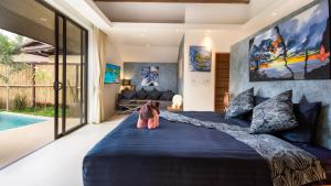a bedroom with a large bed and a pool at Khwan Beach Resort - Luxury Glamping and Pool Villas Samui - Adults Only - SHA Extra Plus in Mae Nam