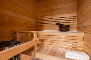 a wooden sauna with a bucket in the middle at New apartment with sauna, lake and beach in Tampere