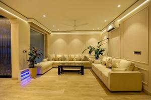 a living room with couches and a table at Millora Cyber Suites, DLF Phase 3 in Gurgaon