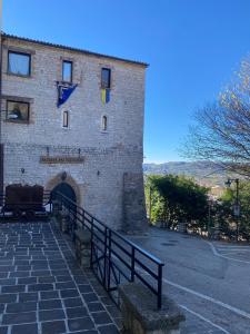 a large brick building with a gate in front of it at Casa La Turchese in Gualdo Tadino