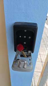 a metal box with a red object in it at Angelina's Home and Spa Alexandroupolis in Alexandroupoli