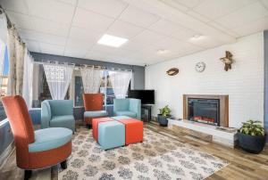 a living room with chairs and a fireplace at Quality Inn - On The Lake Clarksville-Boydton in Clarksville
