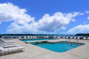 a swimming pool with chairs and a view of the water at Quality Inn - On The Lake Clarksville-Boydton in Clarksville