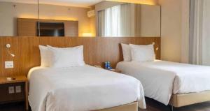 Giường trong phòng chung tại Radisson Blu São Paulo