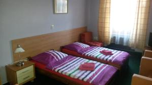 Postel nebo postele na pokoji v ubytování Guest House U Zámku