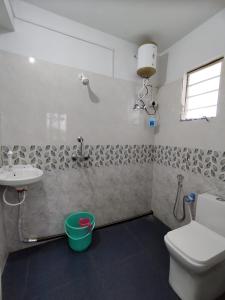 a bathroom with a toilet and a sink at Marmen Homestay in Kalimpong