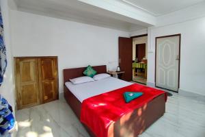 a bedroom with a bed with a red blanket on it at Marmen Homestay in Kalimpong +23 photos