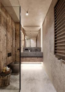 a bathroom with a tub and a sink and a mirror at Giewont View Sośnica Residence & Spa in Zakopane