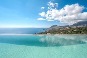 a large body of water with an island in the distance at Dione Villa in Sellía