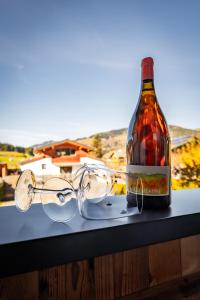 a bottle of wine and glasses sitting on a table at S Apartment in Flachau