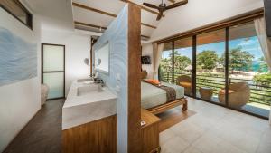 a bedroom with a sink and a bed with a view at Khwan Beach Resort - Luxury Glamping and Pool Villas Samui - Adults Only - SHA Extra Plus in Mae Nam