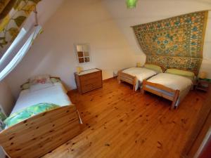 a bedroom with two beds and a wooden floor at Etape à Villeperdue in La Barillonnerie
