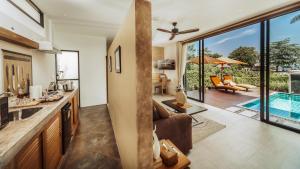 an open kitchen and living room with a pool at Khwan Beach Resort - Luxury Glamping and Pool Villas Samui - Adults Only - SHA Extra Plus in Mae Nam