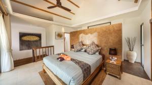 a bedroom with a bed with a pumpkin on it at Khwan Beach Resort - Luxury Glamping and Pool Villas Samui - Adults Only - SHA Extra Plus in Mae Nam