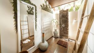 a hallway with two vases on the floor and a ladder at Khwan Beach Resort - Luxury Glamping and Pool Villas Samui - Adults Only - SHA Extra Plus in Mae Nam