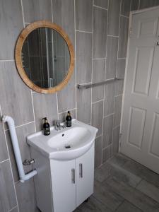 a bathroom with a white sink and a mirror at Unit 8 Hermanus Beach Club in Hermanus +10 photos