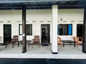 a group of chairs and tables on a patio at moments hotel & restaurant in Hikkaduwa