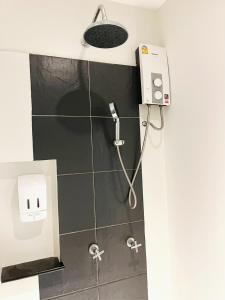 a shower in a bathroom with a shower at Phuketa - SHA Extra Plus in Phuket Town