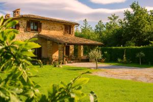 a stone house with a gazebo in a yard at VILLA NASCA - Ville Carborello in Castelraimondo